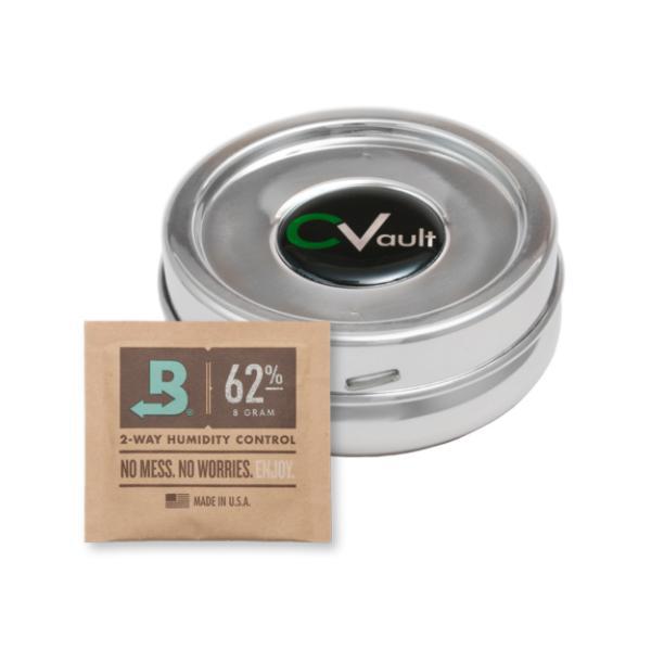 A CVault Humidity Control Airtight Metal Smell Proof Container sits beside a brown 62% humidity control packet labeled No Mess. No Worries.